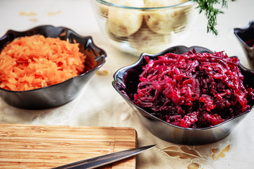 preparing russian traditional salad 'herring under fur coat'