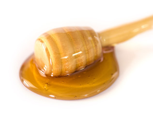 Honey with a Honey Spoon on a White Background