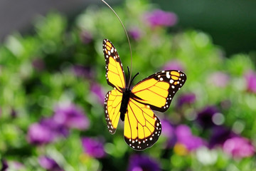 Artificial butterfly on a floral background
