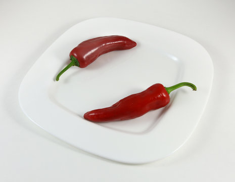 Red chili pepper on a white plate