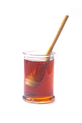 Honey with a Honey Spoon in a Glass Container