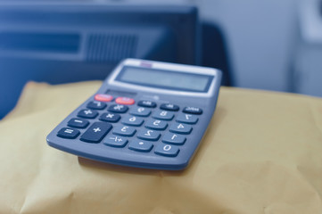 Closeup on calculator over light desk background. Top side view flat lay style of digital compute technology idea