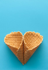 Empty waffle cup on blue backfround.
