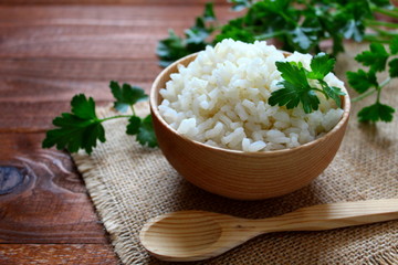 White rice in wooden bowl.Top view.