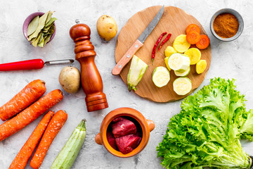 Traditional vegetable dish cooked in oven on stone background top view
