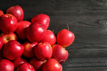 Fresh ripe red apples on wooden background