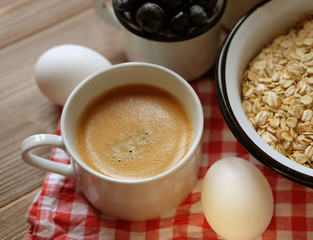 healthy eating and diet concept: oatmeal, boiled egg, milk, fres