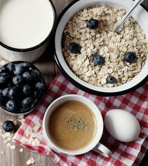 A healthy breakfast - oatmeal, boiled egg, milk, fresh berries a