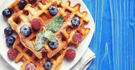 Traditional belgian waffles with fresh berrys and sugar powder