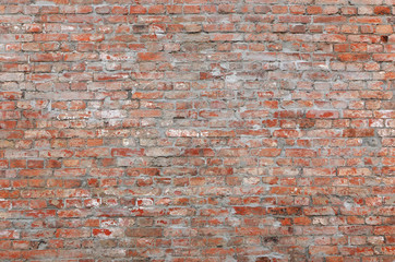 An ancient motley red brick wall