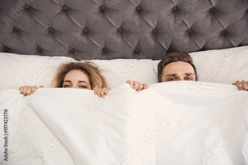 Lovely Young Couple Lying In Bed At Home Stock Photo And