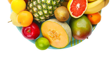Plate with fresh tropical fruits on white background
