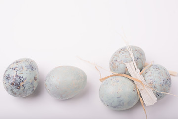 Easter spring composition with quail eggs on a white surface. Easter greeting card. Happy Easter. Space for text.
