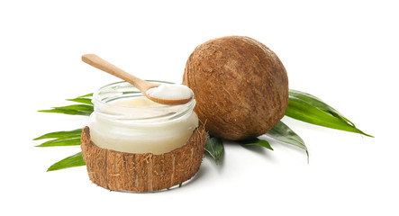 Jar with coconut oil and nut on white background