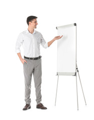 Business trainer giving presentation on flip chart board against white background