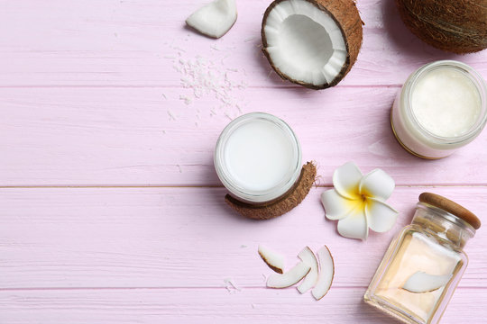 Beautiful composition with coconut oil and nuts on color wooden background