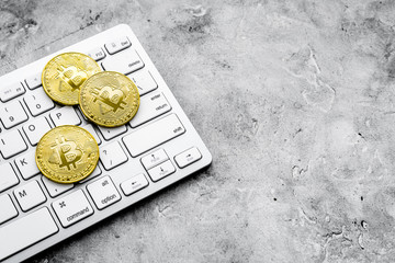 online payment with golden bitcoins and keyboard on gray background mock-up