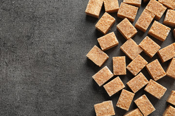 Cubes of brown sugar on gray background
