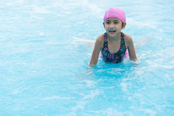 Fototapeta na wymiar Asian Kids cute little girl Swimming in the pool summer