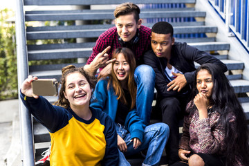 Group of school friends having fun and taking a selfie