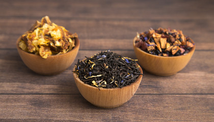 Loose Leaf Tea in a Wooden Bowl on a Wooden Table