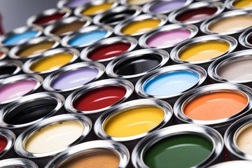 Buckets full of rainbow colored oil paint