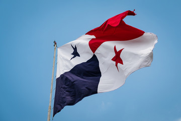 National flag of Panama with skyline of Panama City in background