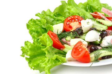Fresh vegetable salad in a plate. Restaurant serving. Isolated.
