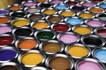 Buckets full of rainbow colored oil paint