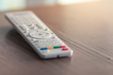 white TV remote is placed on the table.