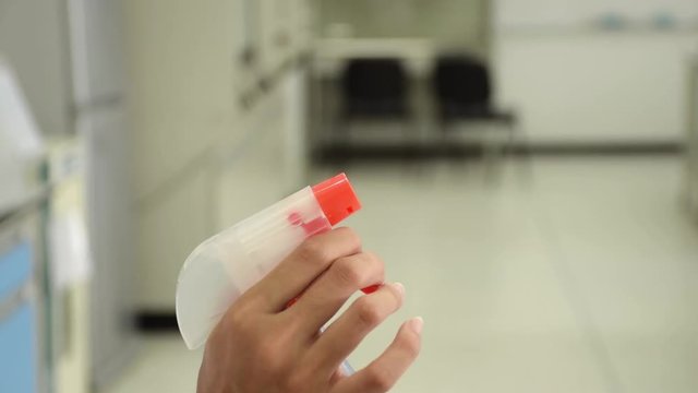 Closeup of water spraying tool nozzle with 70% ethanol alcohol for cleaning and hygiene in science laboratory.