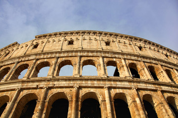 Fototapeta premium Ancient Roman Coliseum against a blue summer sky