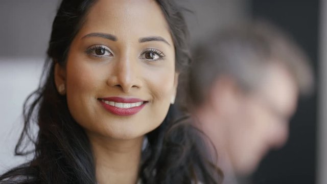 Portrait of smiling Indian woman looking to camera