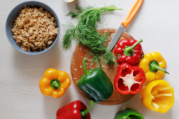 Raw colorful peppers stuffed  with chopped meat and rise