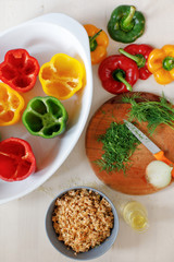 Raw colorful peppers stuffed  with chopped meat and rise