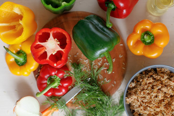 Raw colorful peppers stuffed  with chopped meat and rise