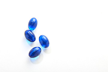 Blue pills capsule on white background
