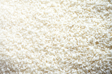 White raw organic basmati rice background. Food ingredient background. Top view, healthy lifestyle concept.
