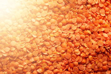 Red raw organic lentils texture. Food ingredient background. Top view