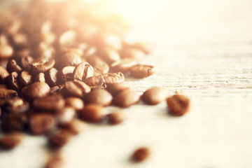 Coffee beans on light wooden background with copyspace for text. Coffee background, food frame,...