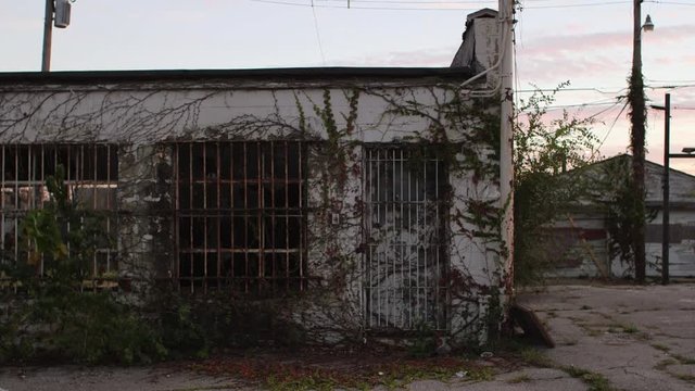 A wide shot of an abandoned building at dusk.