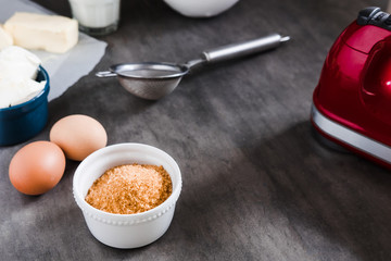 Baking ingredients, preparing dough on dark background from above. Copy space, horizontal