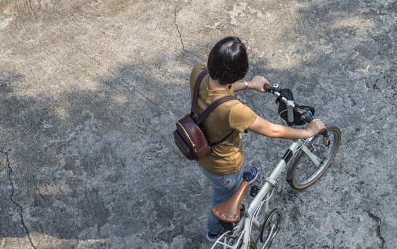 Asian woman with folding bicycle