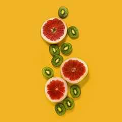 Fresh Fruits on a Yellow Background, Kiwi and Grapefruit