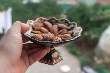 Various useful and tasty almonds in a pot handed