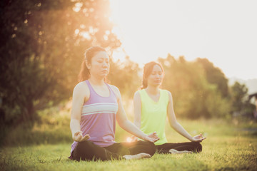 Young asian woman exercising in park.