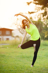 Young asian woman exercising in park.