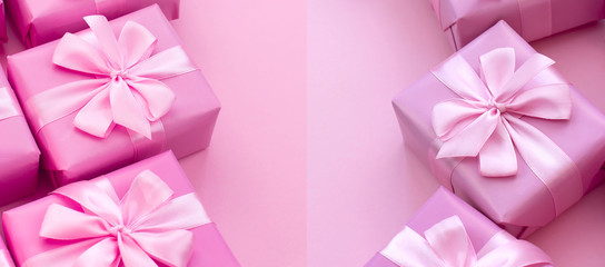 Banner Decorative holiday gift boxes with pink color on pink background.