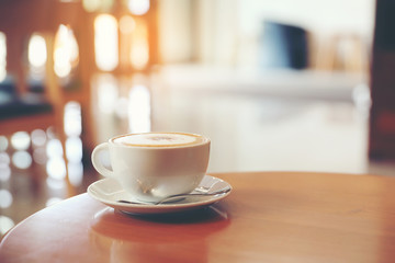 cappuccino or Latte art coffee made from milk on the wood table in coffee shop