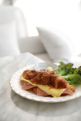 Sandwich ham and cheese on white table in coffee shop